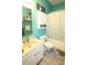 Cozy aqua-toned bathroom with a tub/shower combination, updated vanity, and a coordinating neutral-toned tile flooring at 1545 Lewis Farm Rd, Kings Mountain, NC 28086