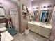 Well-lit bathroom with dual sinks, tile flooring, and a shower-tub combination at 1545 Lewis Farm Rd, Kings Mountain, NC 28086