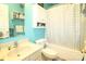 Cozy aqua-toned bathroom with a tub/shower combination, updated vanity, and a coordinating neutral-toned tile flooring at 1545 Lewis Farm Rd, Kings Mountain, NC 28086