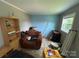 A cozy bedroom featuring a window with natural light, a chair, and some shelves at 1545 Lewis Farm Rd, Kings Mountain, NC 28086
