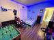 Fun bedroom with LED strip lighting, foosball table, hardwood flooring, and ceiling fan at 1545 Lewis Farm Rd, Kings Mountain, NC 28086