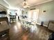 Open dining area with wood floors and a ceiling fan adjacent to double doors and the kitchen at 1545 Lewis Farm Rd, Kings Mountain, NC 28086
