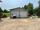 Detached garage with two bays, a parking pad, and lawn furniture at 1545 Lewis Farm Rd, Kings Mountain, NC 28086