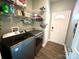 Bright laundry area features a modern washer and dryer with ample shelving above and gray wood-look flooring at 1545 Lewis Farm Rd, Kings Mountain, NC 28086