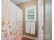 Bathroom with a shower/tub combination featuring a patterned shower curtain and neutral decor at 1621 California Rd, York, SC 29745