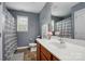 A gray bathroom with a white sink, wood cabinets, and a toilet; providing comfort and functionality at 1621 California Rd, York, SC 29745