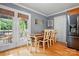 Bright dining area with hardwood floors, wooden dining table, and access to an outdoor patio through glass doors at 1621 California Rd, York, SC 29745