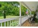 Charming front porch with rocking chairs offers picturesque views of the lush surroundings at 1621 California Rd, York, SC 29745