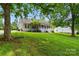 View of the house, showing the front yard, a mature shade tree and rope swing at 1621 California Rd, York, SC 29745