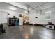 A clean garage space featuring a shoe rack, refrigerator, storage, and epoxy flooring at 1621 California Rd, York, SC 29745