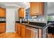 Kitchen featuring wood cabinets, stainless steel dishwasher, and granite countertops with integrated sink at 1621 California Rd, York, SC 29745