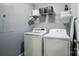 Laundry room with a washer and dryer, shelving for storage, and a light gray painted wall at 1621 California Rd, York, SC 29745