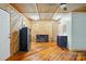 Living room with wood walls, a refrigerator, a TV, a fan, and a vanity at 1621 California Rd, York, SC 29745