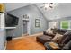 Spacious living room with vaulted ceilings, hardwood floors, and a comfortable seating area with a brown leather sofa at 1621 California Rd, York, SC 29745