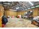 Interior view of the outbuilding featuring storage shelves, a red wheelbarrow, and a high ceiling at 1621 California Rd, York, SC 29745