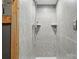 Modern tiled shower with adjustable shower head and built-in shelving for toiletries at 1621 California Rd, York, SC 29745