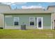 Well-maintained backyard with green siding and a glass panel back door at 1770 Troon Dr, Salisbury, NC 28144