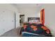Cozy bedroom with neutral carpet, natural light, and black and orange bedding at 1770 Troon Dr, Salisbury, NC 28144