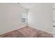 Clean and bright bedroom featuring plush carpet and natural light from a window at 1770 Troon Dr, Salisbury, NC 28144
