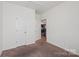 Inviting bedroom with neutral carpet, white doors and trim, and ample natural light at 1770 Troon Dr, Salisbury, NC 28144