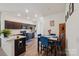 Modern kitchen with stainless appliances, dark cabinets, a breakfast bar, and adjacent dining area at 1770 Troon Dr, Salisbury, NC 28144