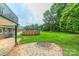 Beautiful backyard with above ground pool, fire pit, and a well-maintained lawn surrounded by lush greenery at 1867 Shannon Dr, Conover, NC 28613