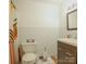 Well-lit bathroom with a modern vanity, toilet, and tiled floors at 1867 Shannon Dr, Conover, NC 28613