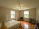 Bright bedroom with hardwood floors, two windows, and a ceiling fan at 1867 Shannon Dr, Conover, NC 28613