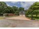 Detached two-car garage with driveway, complemented by beautiful landscaping and exterior features at 1867 Shannon Dr, Conover, NC 28613