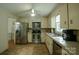 Functional kitchen with stainless steel appliances, tile flooring, and ample cabinet space at 1867 Shannon Dr, Conover, NC 28613