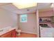 Well-lit laundry room with modern washer and dryer, sink, and storage shelves for convenience at 1867 Shannon Dr, Conover, NC 28613