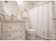 Well-lit bathroom featuring a white vanity, decorative mirror, and shower with a glass door at 19182 Mallard Dr, Fort Mill, SC 29707