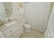 Bright bathroom featuring a white vanity, tile floors, and a shower, offering a clean and modern feel at 19182 Mallard Dr, Fort Mill, SC 29707