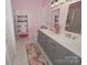 Stylish pink bathroom with a double vanity, modern fixtures, and a glass-enclosed shower for a spa-like feel at 19182 Mallard Dr, Fort Mill, SC 29707