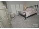 Cozy bedroom with a metal bed frame, soft carpeting, and a large window for natural light at 19182 Mallard Dr, Fort Mill, SC 29707