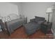 Comfortable bedroom with a daybed, chair, ottoman, and hardwood floors, ideal for relaxation at 19182 Mallard Dr, Fort Mill, SC 29707