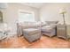 Cozy bedroom featuring hardwood floors, comfortable seating area, and natural light from the window at 19182 Mallard Dr, Fort Mill, SC 29707