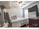 Comfortable bedroom featuring neutral tones, a ceiling fan, and a large window with blinds at 19182 Mallard Dr, Fort Mill, SC 29707