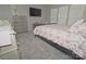 A nicely decorated bedroom with soft carpet, a comfy bed, chest of drawers, and a TV at 19182 Mallard Dr, Fort Mill, SC 29707