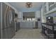 Well-lit kitchen featuring stainless steel appliances, gray lower cabinets, and a view into the dining room at 19182 Mallard Dr, Fort Mill, SC 29707