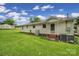 Expansive backyard featuring lush green lawn and a back door leading to a patio area at 2084 Old Evans Cir, Lancaster, SC 29720