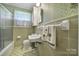 Bathroom features a tiled shower and a vintage sink at 2084 Old Evans Cir, Lancaster, SC 29720