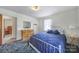 Bright bedroom with a white iron bed frame and blue comforter at 2084 Old Evans Cir, Lancaster, SC 29720