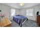 Bright bedroom with a white iron bed frame and blue comforter at 2084 Old Evans Cir, Lancaster, SC 29720