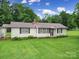 Charming one-story home with a manicured front lawn and mature trees at 2084 Old Evans Cir, Lancaster, SC 29720
