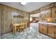 Eat-in kitchen with tile floors and wood paneled walls at 2084 Old Evans Cir, Lancaster, SC 29720