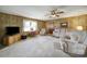 Well-lit living room with wood-paneled walls, carpet, and comfortable seating arrangement at 2084 Old Evans Cir, Lancaster, SC 29720