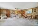 Spacious living and dining area with wood-paneled walls and neutral carpet at 2084 Old Evans Cir, Lancaster, SC 29720