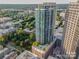 An aerial shot shows the building's unique rooftop pool and its relationship to nearby buildings at 210 N Church St # 2807, Charlotte, NC 28202