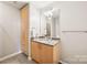Clean bathroom with a granite countertop, modern vanity, and ample storage space at 210 N Church St # 2807, Charlotte, NC 28202